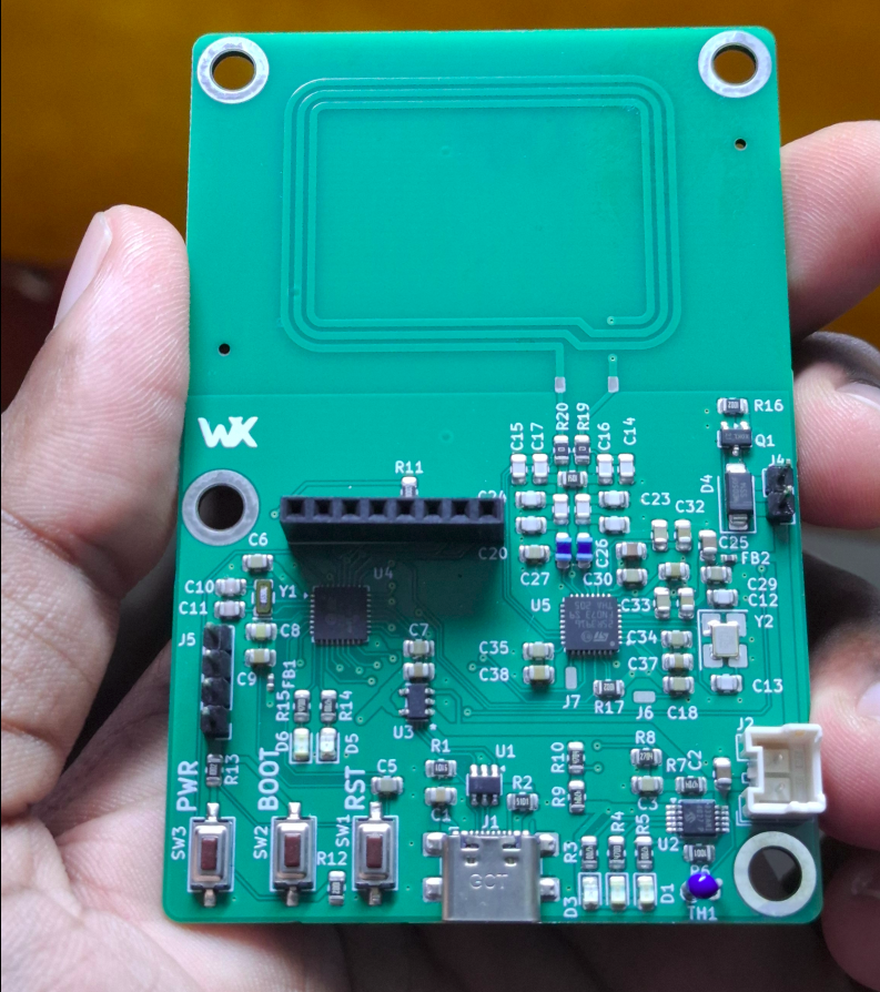 Assembled NFC attendance logger PCB held in hand